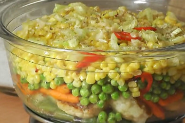 Frozen beans with corn and herbs in a frying pan