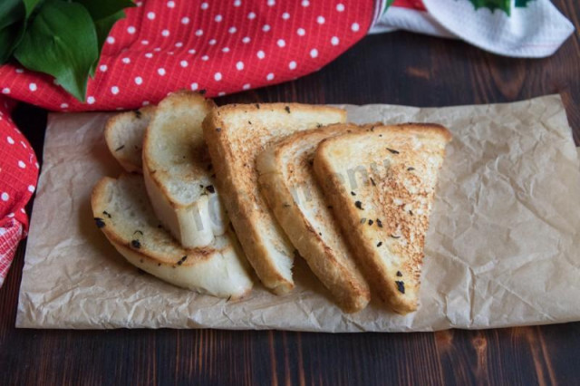 Croutons of white bread in a frying pan