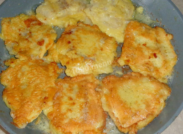 Pollock in batter in a pan with pancakes