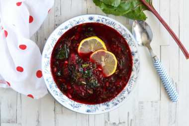 Classic cold borscht with boiled beetroot and tops