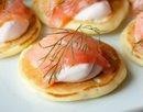 Mini pancakes with salmon and hot cream