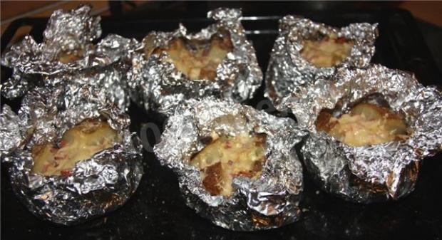 Baked potatoes with meat on a campfire