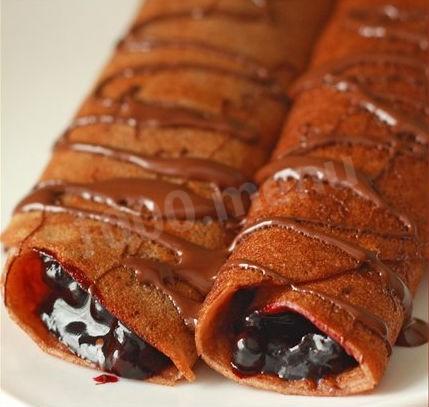 Delicious chocolate pancakes with blueberries