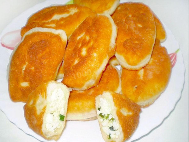 Fried yeast pies with egg and onion filling