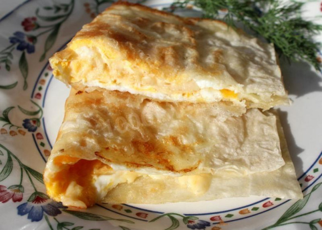 Fried pita bread with egg and hard cheese