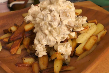 Fried potatoes with oyster mushrooms in a frying pan