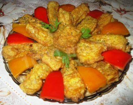 Pumpkin fried in batter in a frying pan