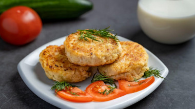 Minced pollock fish cutlets in a frying pan