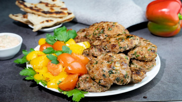 Lula-minced meat kebab with spices in a frying pan