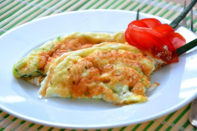 Egg white omelet with milk and herbs in a frying pan