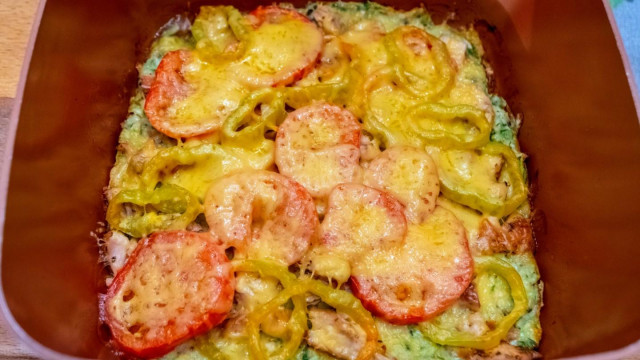 Zucchini pizza with tomatoes and chicken breast in a frying pan