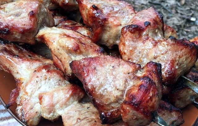Shish kebab from pork neck without marinade on coals