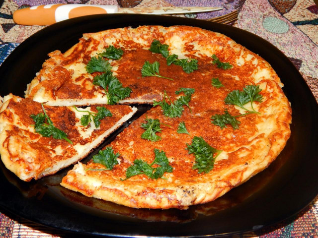 Khachapuri in a frying pan with cottage cheese and hard cheese quick
