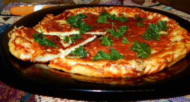Khachapuri in a frying pan with cottage cheese and hard cheese quick