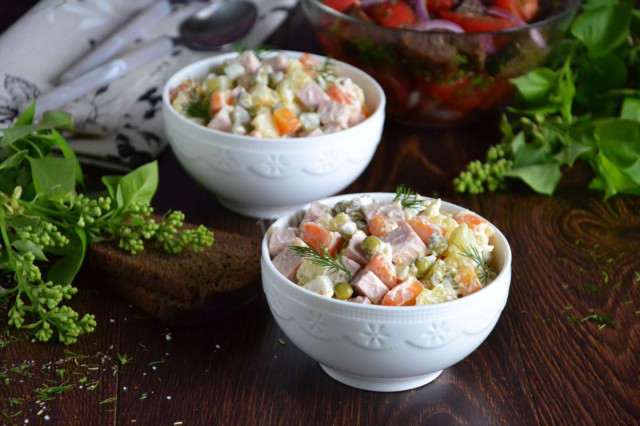 Classic olivier salad with sausage and peas