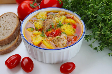 Stewed potatoes with pork in a saucepan