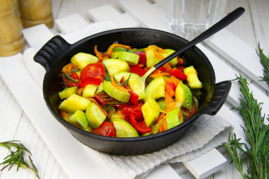 Stewed zucchini with vegetables in a frying pan