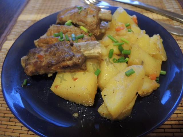 Stewed pork ribs in a slow cooker with potatoes