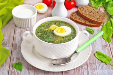 Green cabbage soup with nettle and sorrel with egg