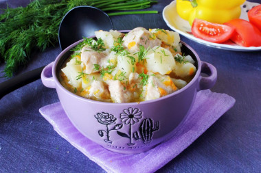 Stewed potatoes with chicken fillet in saucepan