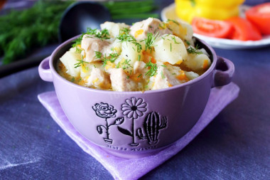 Stewed potatoes with chicken fillet in saucepan