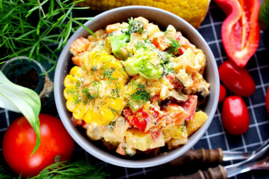 Stewed vegetables in sour cream in a frying pan