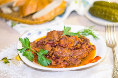 Stewed meat with beans in tomato sauce