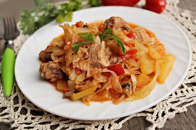 Stewed cabbage with pork, vegetables and potatoes in a slow cooker