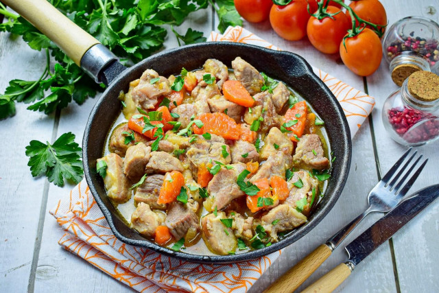 Pork with onions and carrots in a frying pan