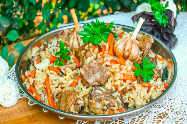 Beef pilaf in a cauldron over a campfire