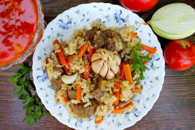 Beef pilaf in a cauldron over a campfire