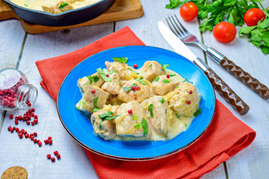 Chicken fillet in sour cream in a frying pan