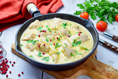 Chicken fillet in sour cream in a frying pan