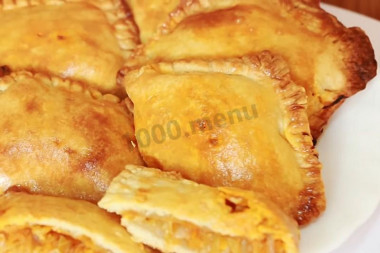 Puff pastry pies with cabbage in the oven