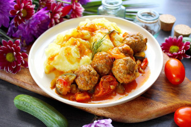 Meatballs with vegetables in a frying pan