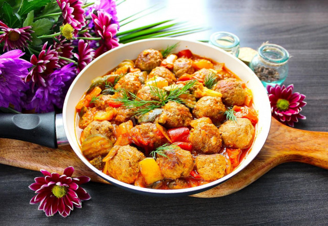 Meatballs with vegetables in a frying pan