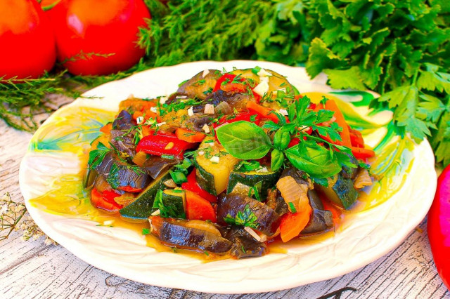 Saute zucchini and eggplant with vegetables in a frying pan