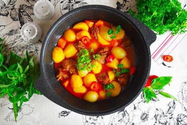 Roast beef in a cauldron on the stove