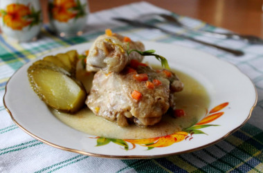 Chicken legs in sour cream sauce in a frying pan