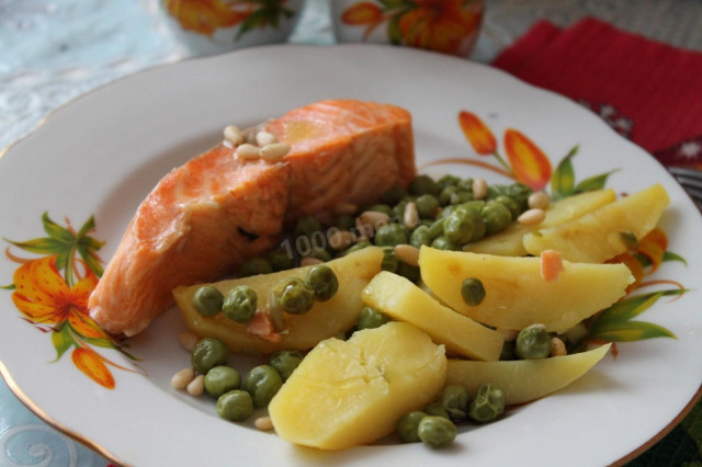 Salmon steak with bay leaf in a frying pan