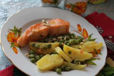 Salmon steak with bay leaf in a frying pan