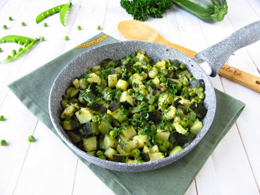 Zucchini with green peas in a frying pan