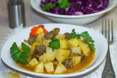 Potatoes with beef and carrots in a slow cooker