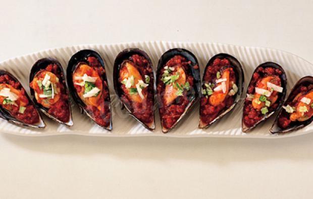 Mussels in half shells with tomato sauce