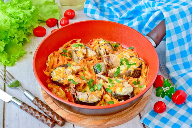 Mackerel with onions and carrots in a frying pan