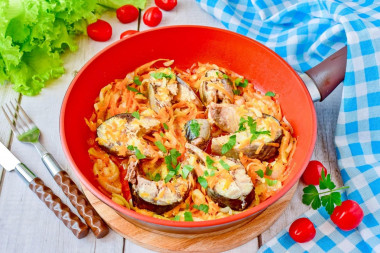 Mackerel with onions and carrots in a frying pan