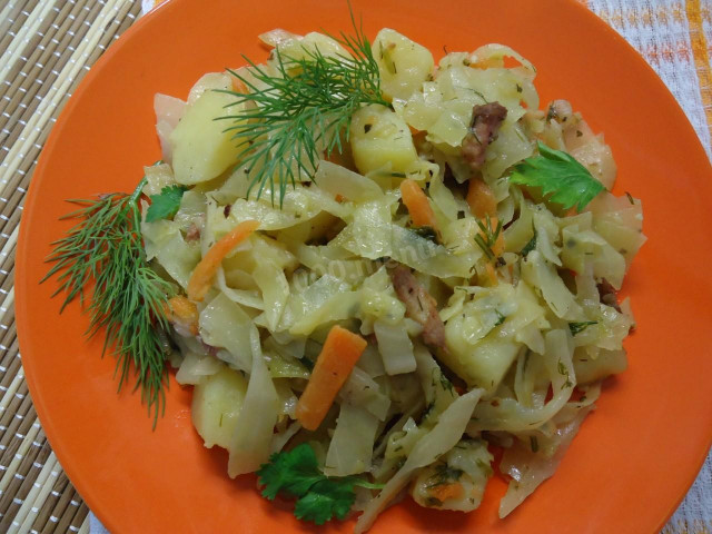 Stewed cabbage with potatoes in a cauldron