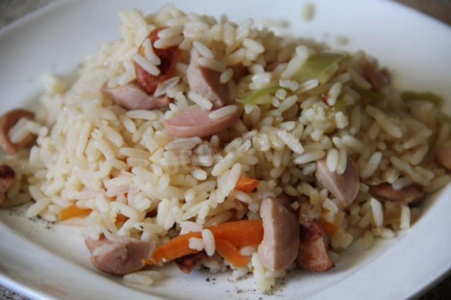 Pilaf with sausages on the stove