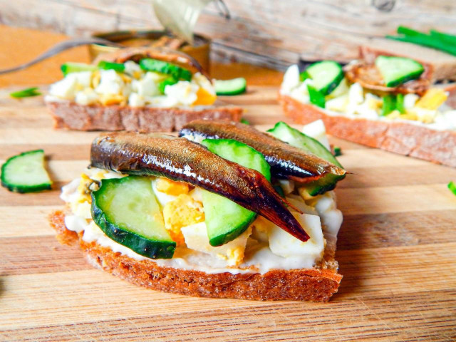 Sandwiches with sprats and fresh cucumber