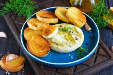 Camembert cheese baked in the oven with garlic